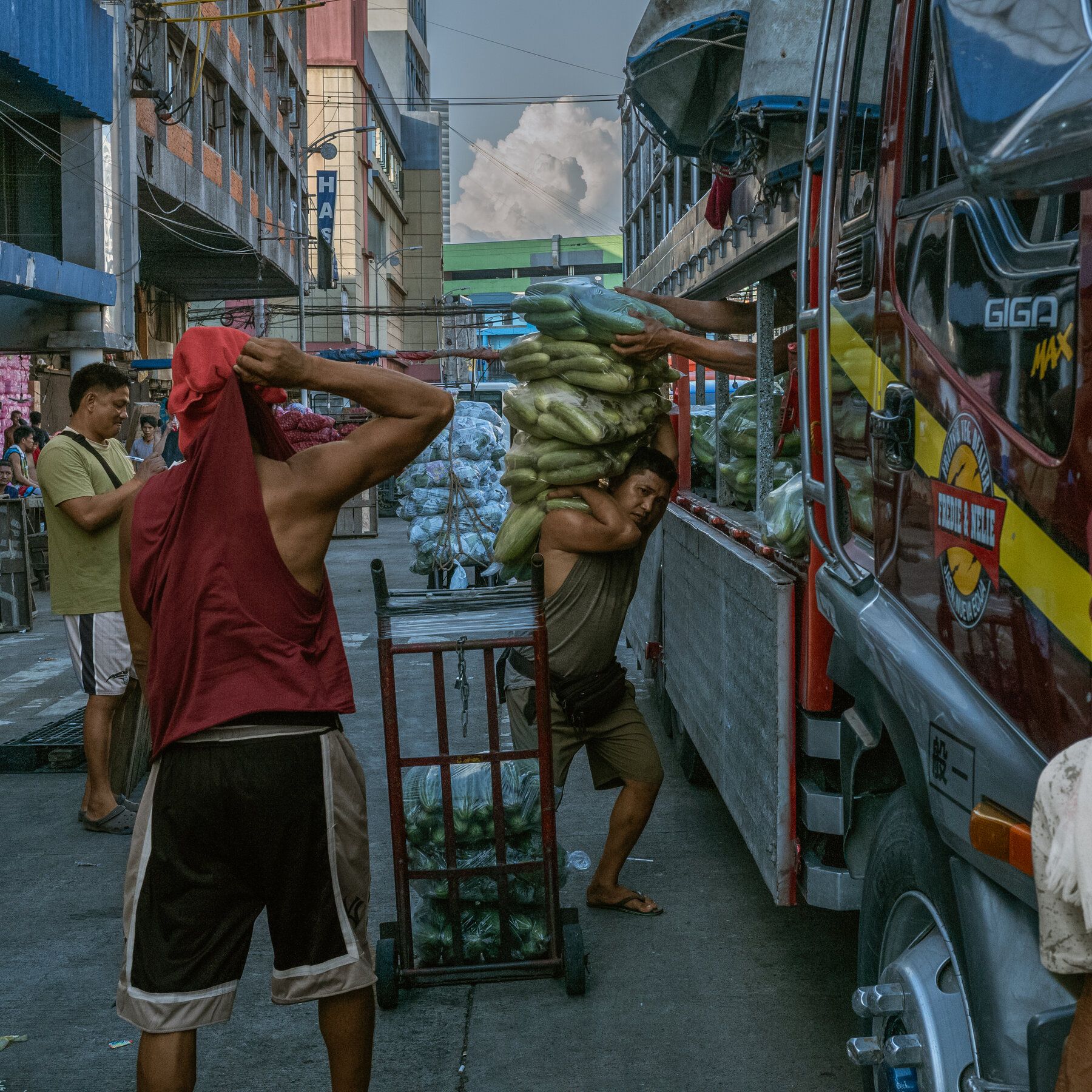 Men loading produce on a vehicle in Manila. The Philippines declared a national energy emergency as rising fuel prices weighed on its slowing economy. - nytimes.com