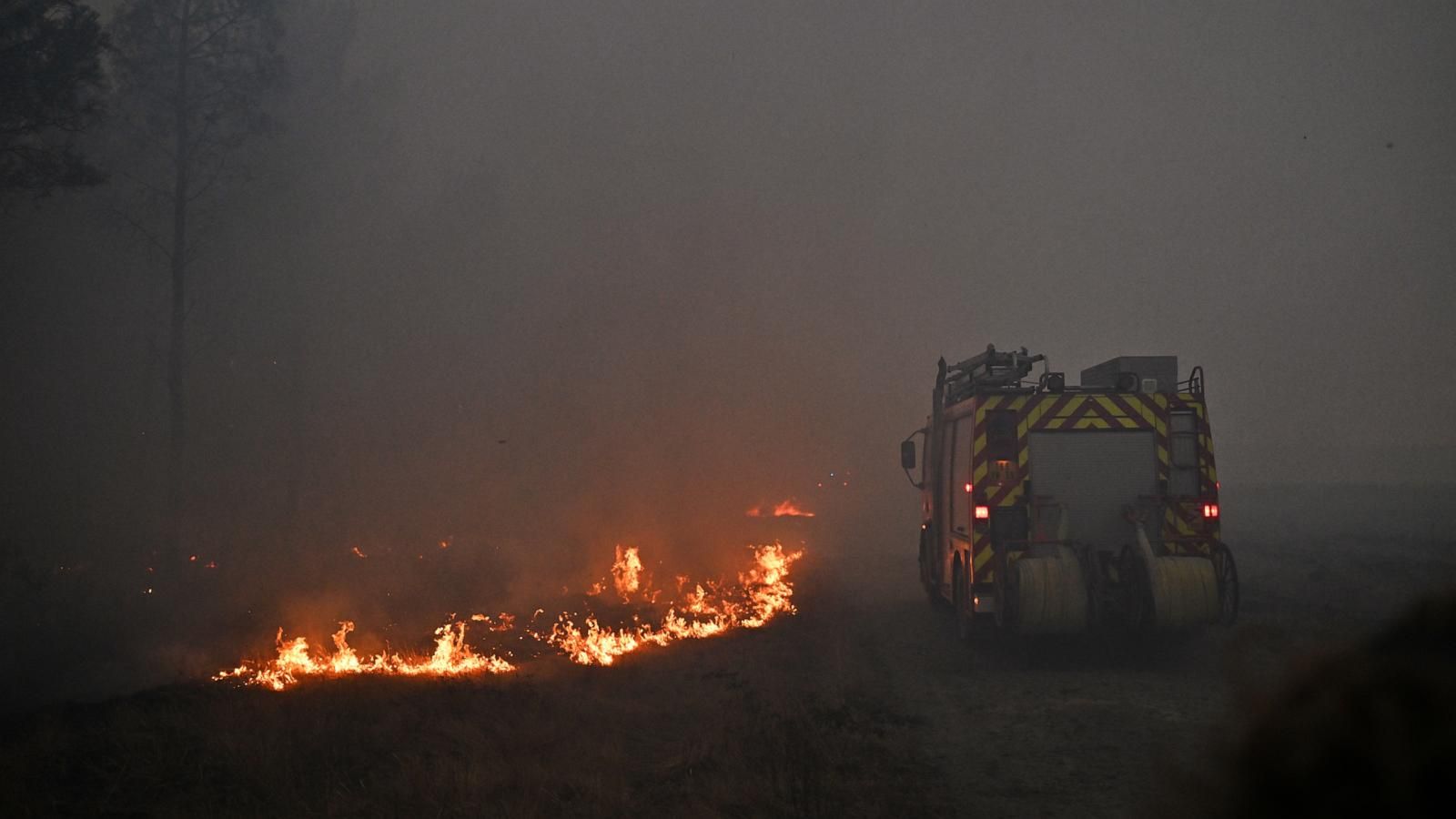 A fire engine drives through smoke from a wildfire near Marcheprime, outside Bordeaux, France, on Sunday. - AP Photo/Emma Da Silva