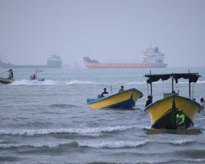 Ships anchored in the Strait of Hormuz off Iran, where disruption has pushed up oil prices. - Razieh Poudat/AP