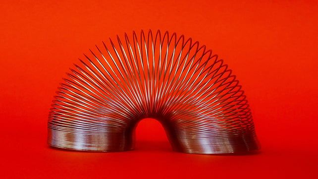 A slinky toy, used in the study coverage as an analogy for DNA packaging that can loosen after early-life stress. - sciencealert.com