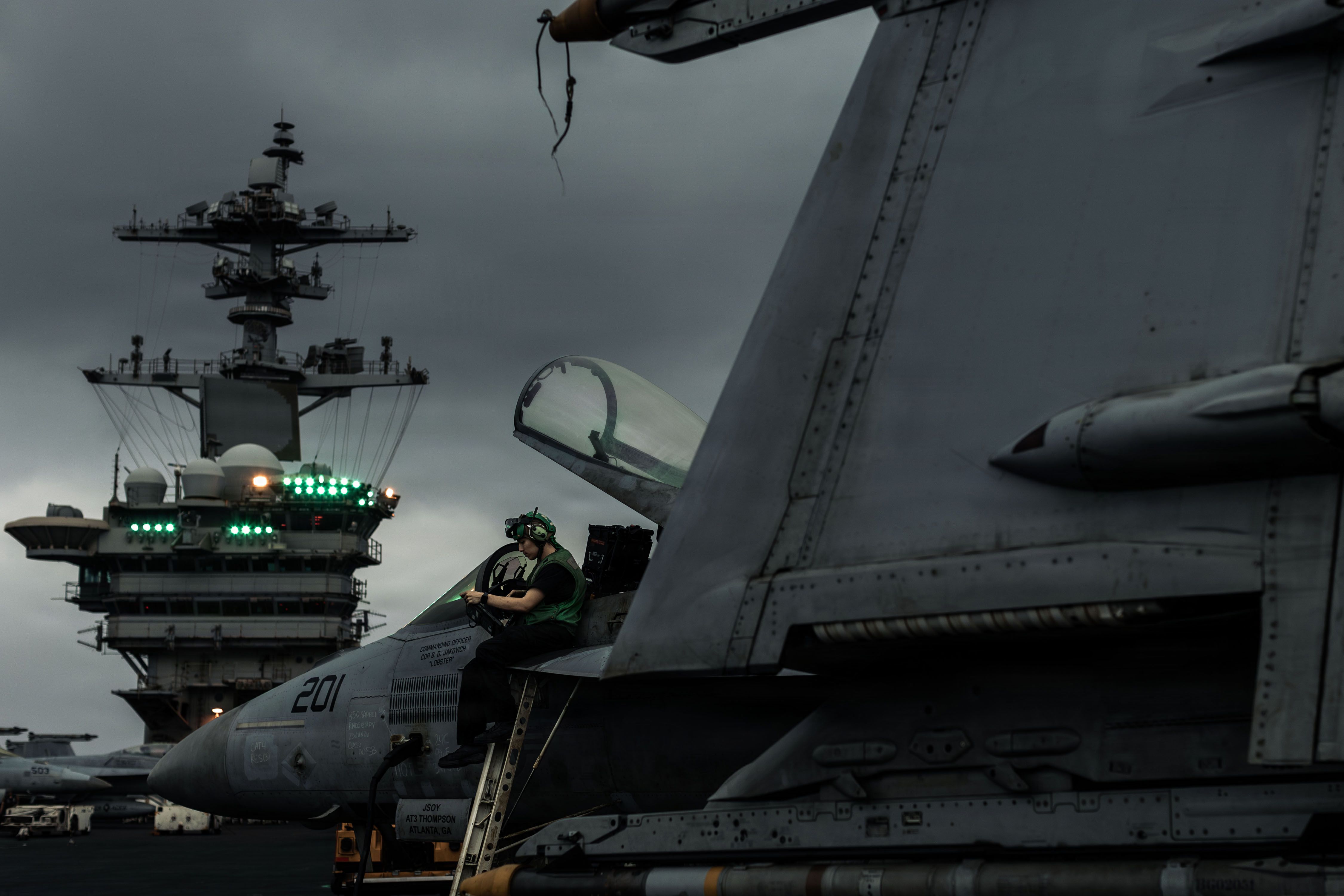 A U.S. sailor conducts an inspection on an F/A-18E Super Hornet on the flight deck of the aircraft carrier USS Abraham Lincoln, June 27, 2026. - U.S. Navy