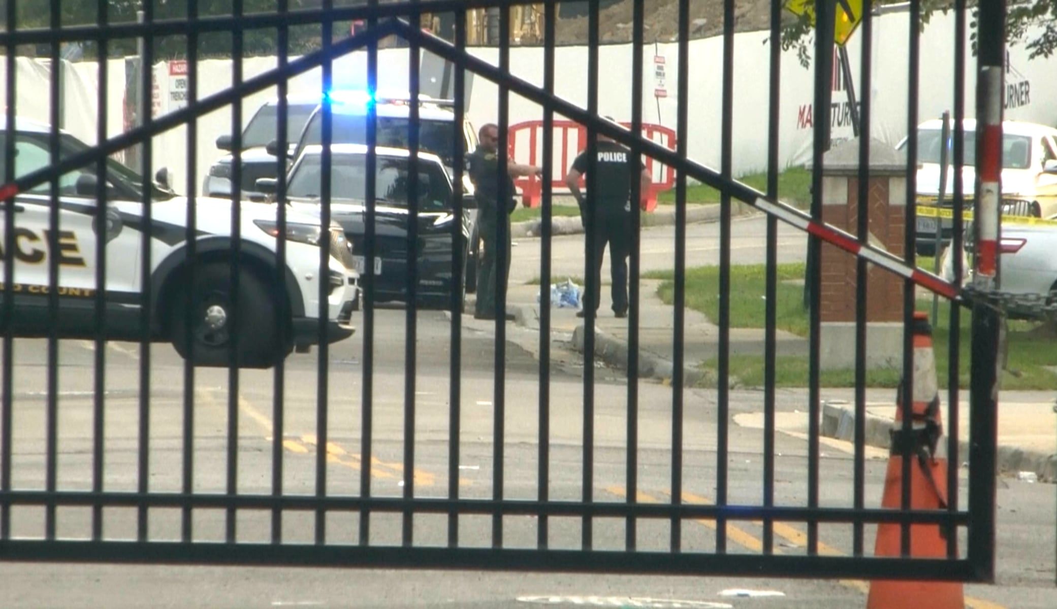 Officers investigate the scene near the Quad Annexes at Virginia State University on Aug. 15, 2026, where five people were injured in a shooting. - WWBT via AP