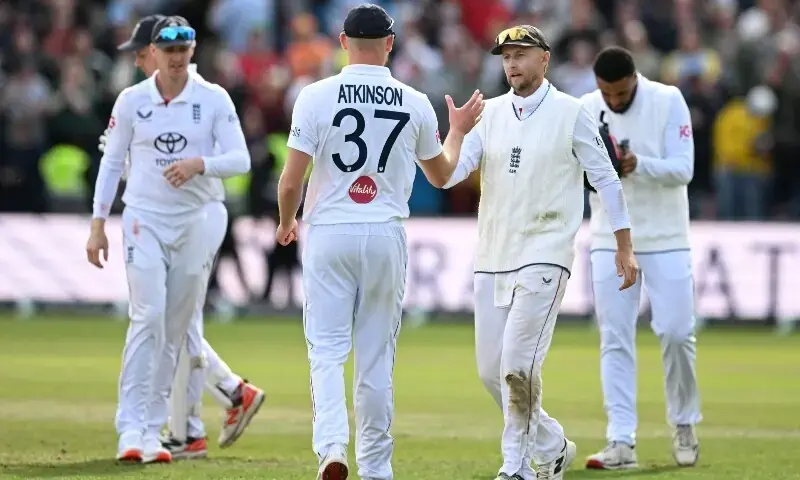 England's Joe Root shakes hands with Gus Atkinson after England win on day three of the first Test against Pakistan at Headingley. - AFP