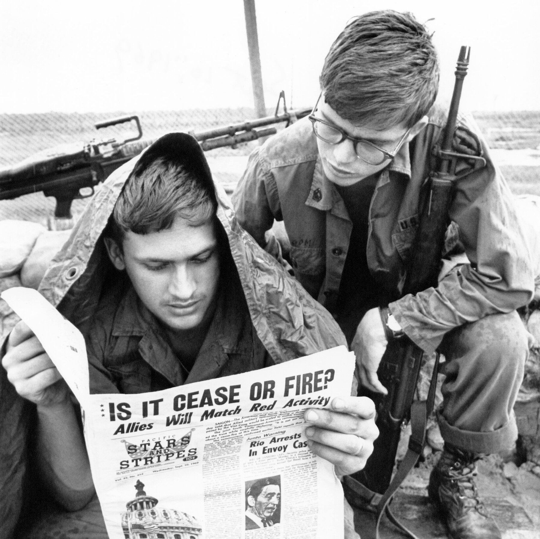 Service members reading Stars and Stripes in Cu Chi, South Vietnam, in September 1969. - The New York Times
