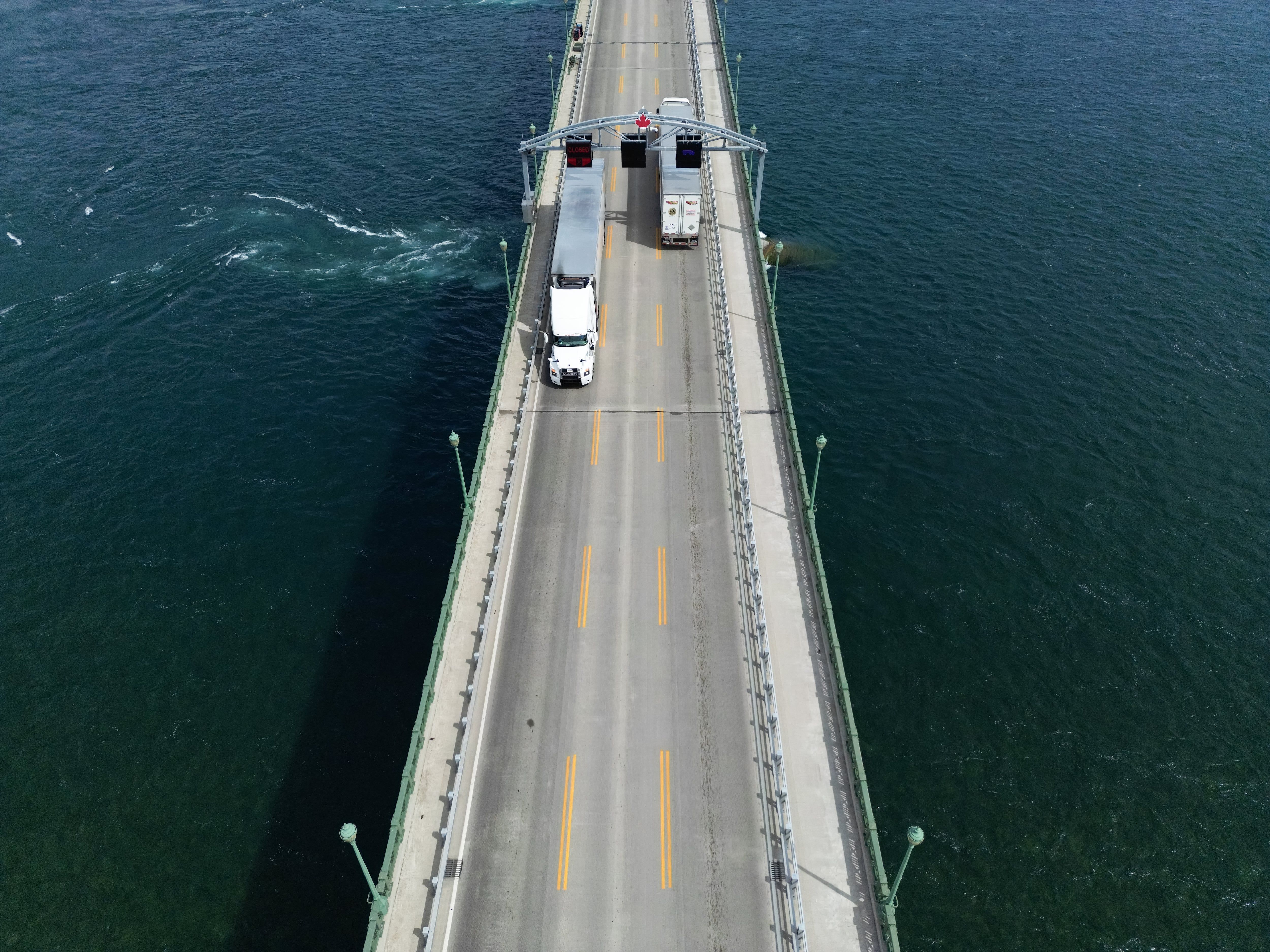Trucks cross the Peace Bridge between Canada and the United States in Fort Erie, Ontario, on Aug. 18, 2026, as negotiators tried to avert new U.S. tariffs. - Cole Burston/AFP via Getty Images