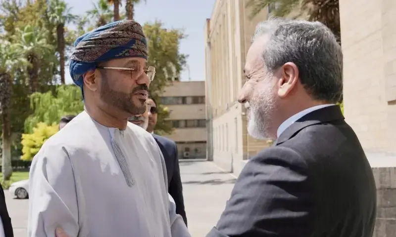 Omani Foreign Minister Badr Albusaidi greets Iran's FM Abbas Araghchi in Tehran. - X/badralbusaidi