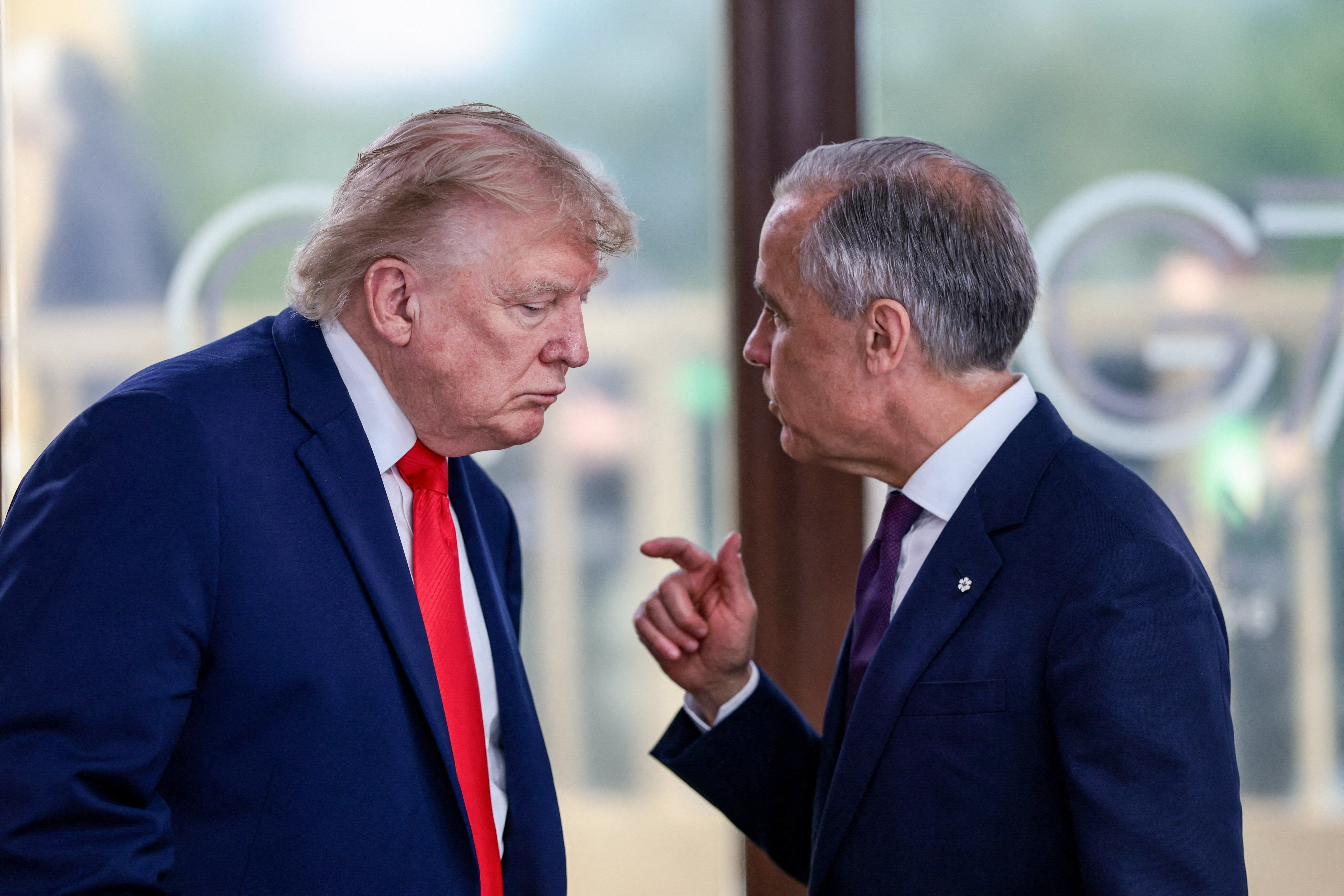 U.S. President Donald Trump speaks with Canadian Prime Minister Mark Carney during a G7 summit work lunch in Evian, France, on June 16, 2026. - Evelyn Hockstein/POOL/AFP via Getty Images