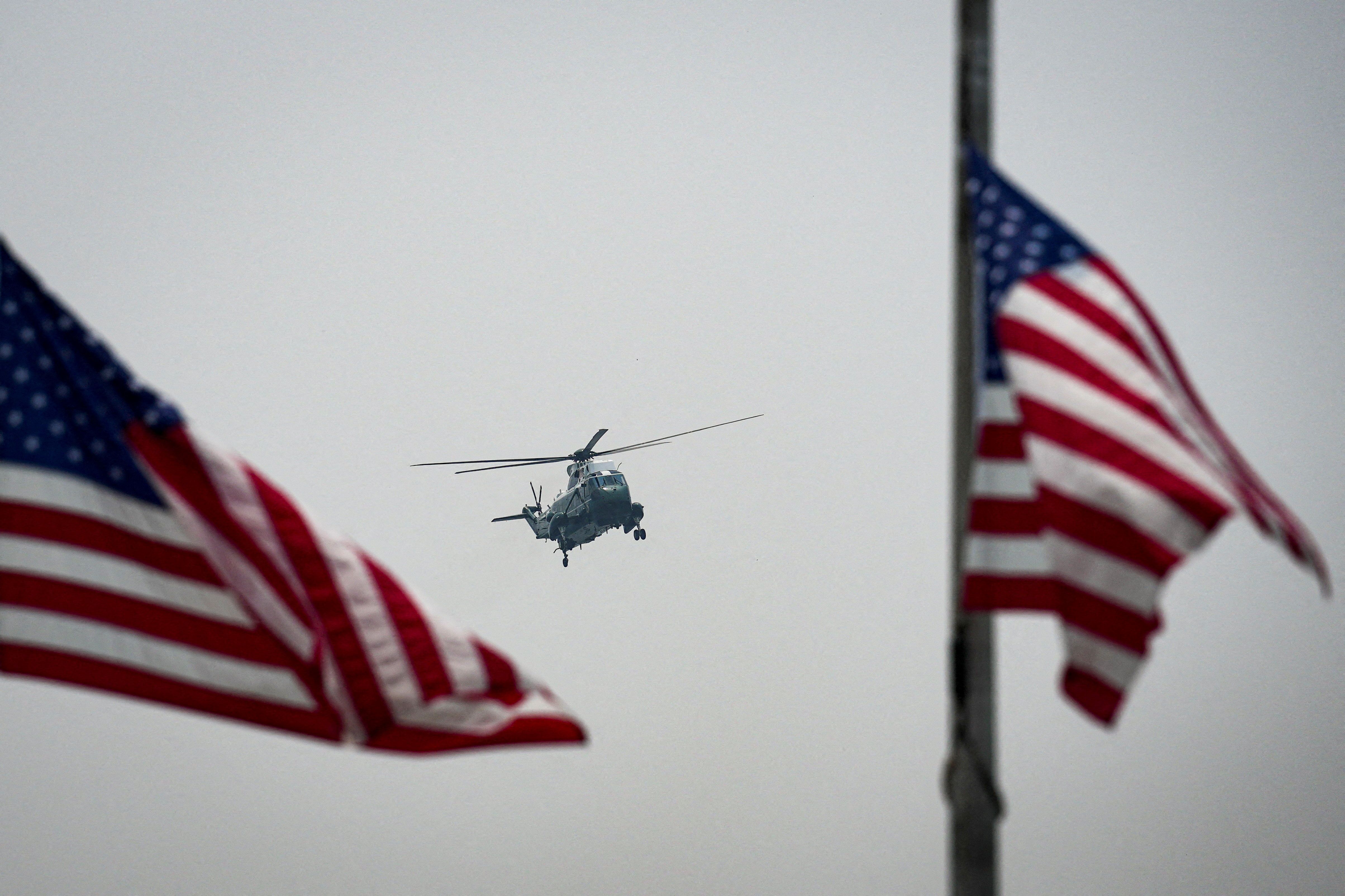 A Sikorsky VH-3D Sea King helicopter, operated by U.S. Marine Helicopter Squadron One, flies past U.S. flags at the base of the Washington Monument on July 17, 2026. - Al Drago/Reuters