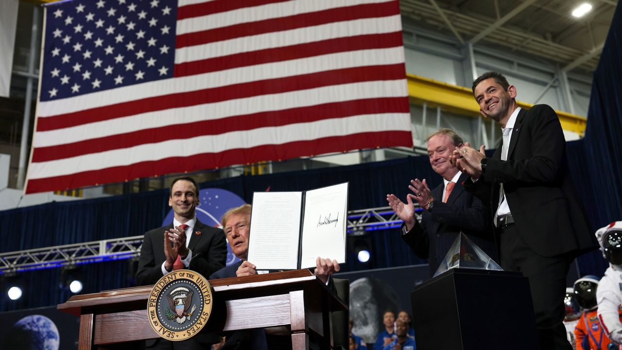 U.S. President Donald Trump displays a signed executive order to create a U.S. Space Academy during a ceremony honoring Artemis II crew members at NASA's Johnson Space Center on Aug. 28, 2026, in Houston, Texas. - Win McNamee/Getty Images