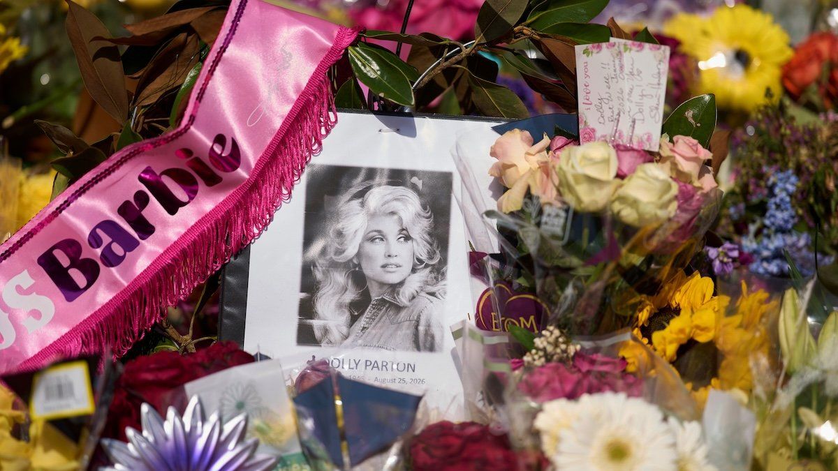 A portrait of Dolly Parton surrounded by flowers and cards sits outside her home in Brentwood, Tennessee, on Aug. 27, 2026. - AP