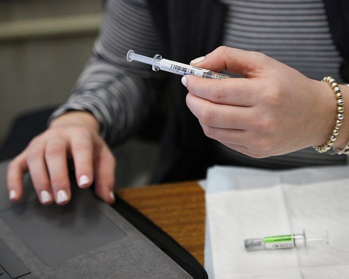 Flu and COVID vaccines are prepared at Boston city hall on January 7, 2026. - Suzanne Kreiter/The Boston Globe via Getty Images