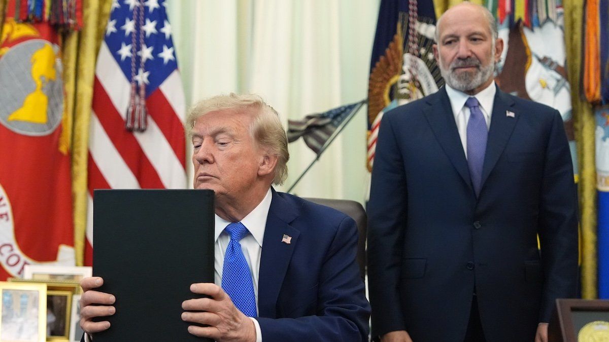 President Donald Trump listens before signing executive orders in the Oval Office of the White House on Aug. 6, 2026, as Commerce Secretary Howard Lutnick watches. - AP
