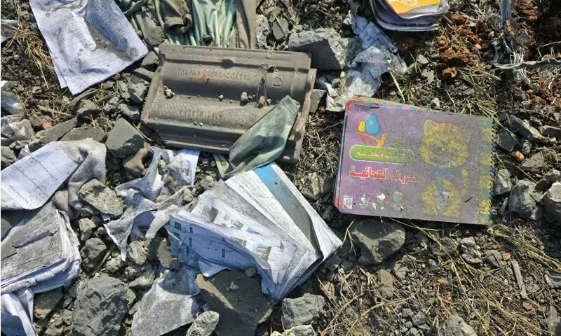 Damaged books lie amidst debris at the site of an Israeli strike, in Kfar Rumman, Lebanon. - Reuters