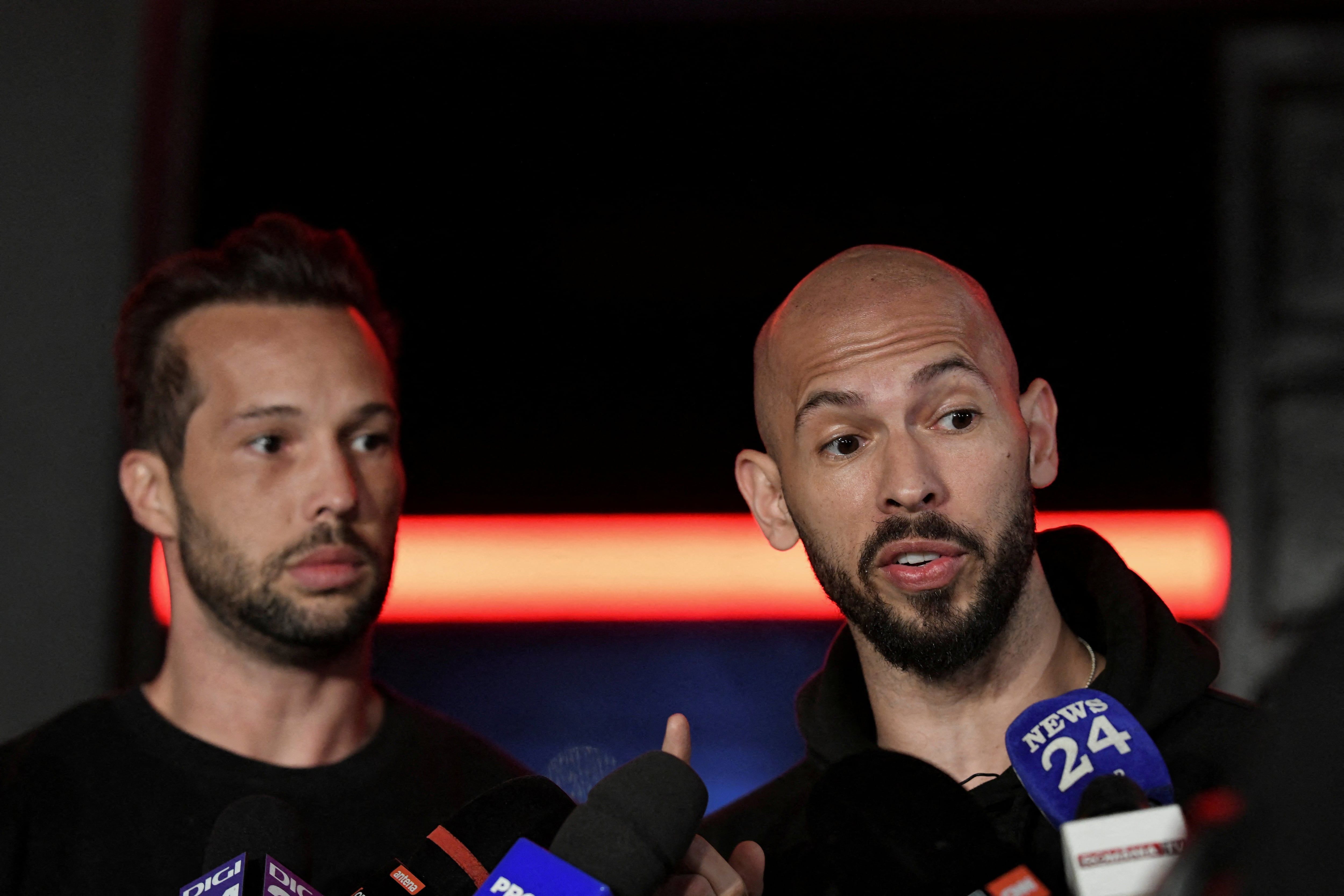 Tristan and Andrew Tate deliver a press statement after landing back in Romania, near Bucharest, on March 22, 2025. - Inquam Photos/Eduard Vinatoru via Reuters