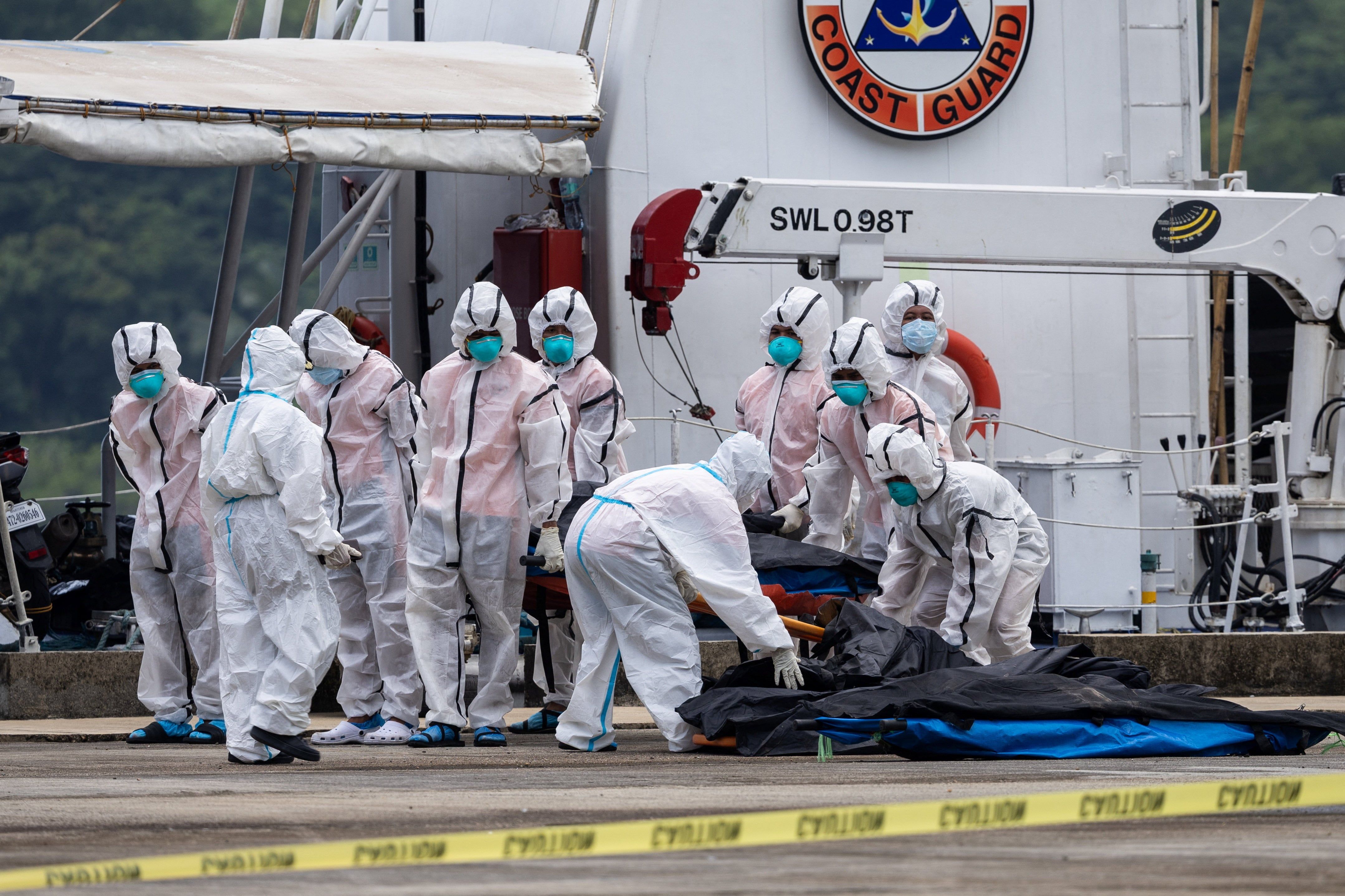 Responders carry the remains of victims after a fire struck the June Aster ferry off Palawan, Philippines. - Reuters