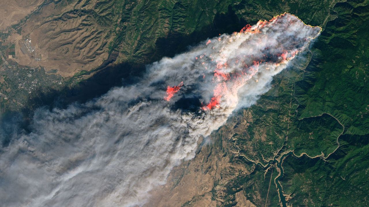 Wildfire smoke billows upward, captured in this image by a NASA satellite. - NASA Earth Observatory image by Joshua Stevens, using Landsat data from the U.S. Geological Survey and MODIS data from NASA EOSDIS/LANCE and GIBS/Worldview