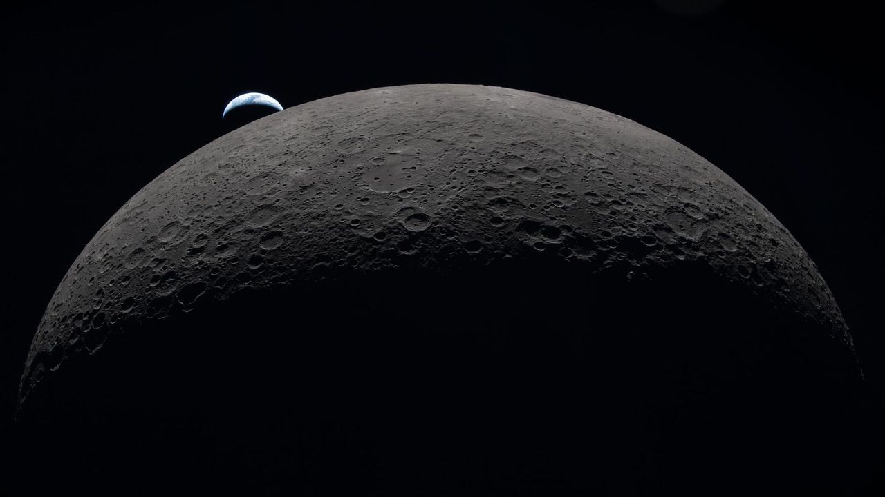 Earth seen above the Moon’s curved limb during the Artemis II mission on April 6, 2026. - NASA